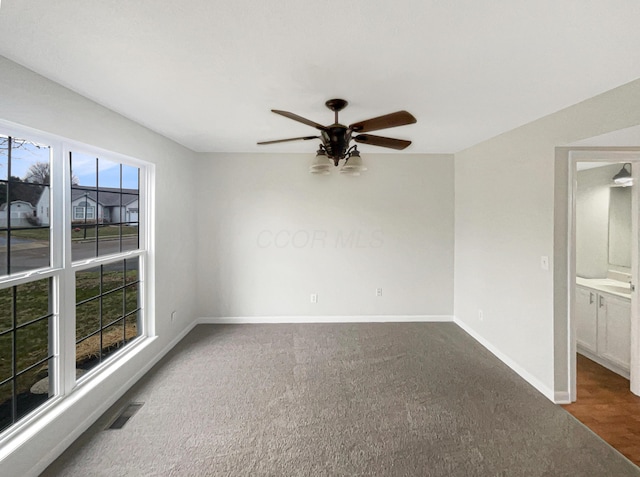 carpeted empty room featuring ceiling fan