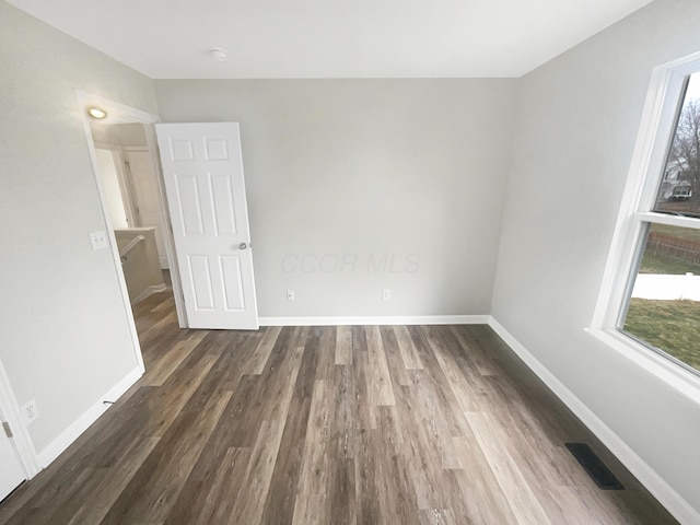 unfurnished room featuring dark wood-type flooring