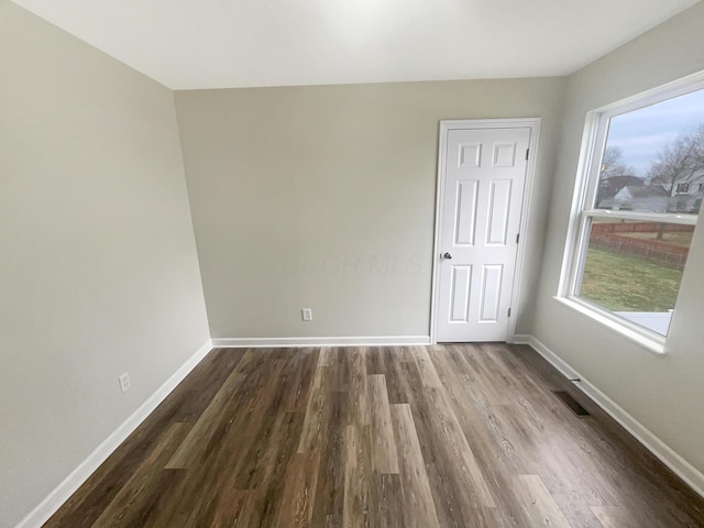 unfurnished room with hardwood / wood-style floors