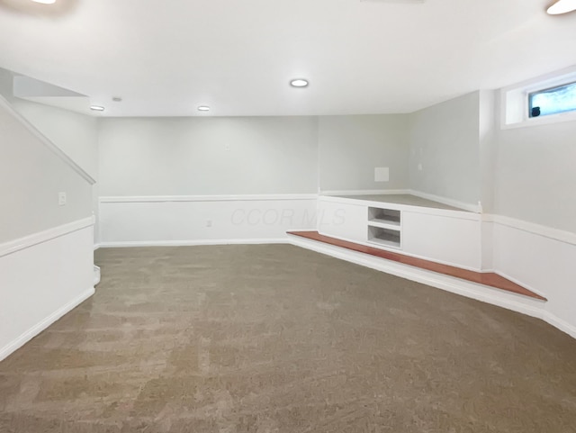 basement featuring dark carpet