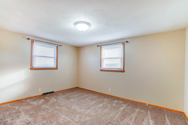 carpeted spare room with plenty of natural light