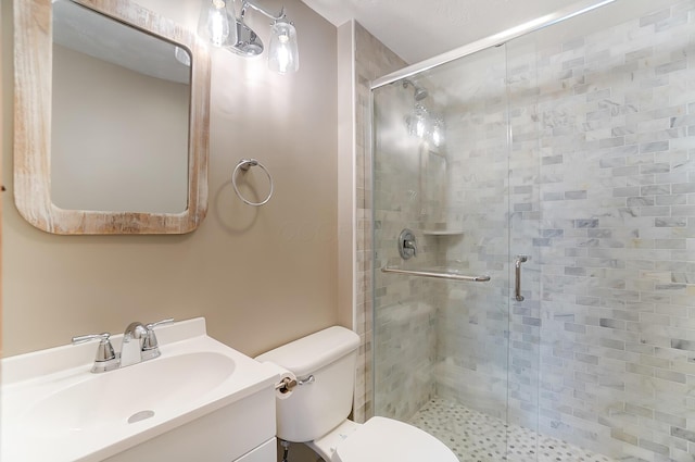 bathroom featuring walk in shower, vanity, and toilet