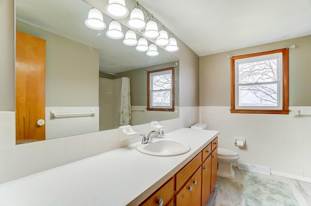 bathroom featuring a shower with curtain, vanity, tile walls, and toilet