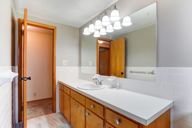 bathroom with vanity and tile walls