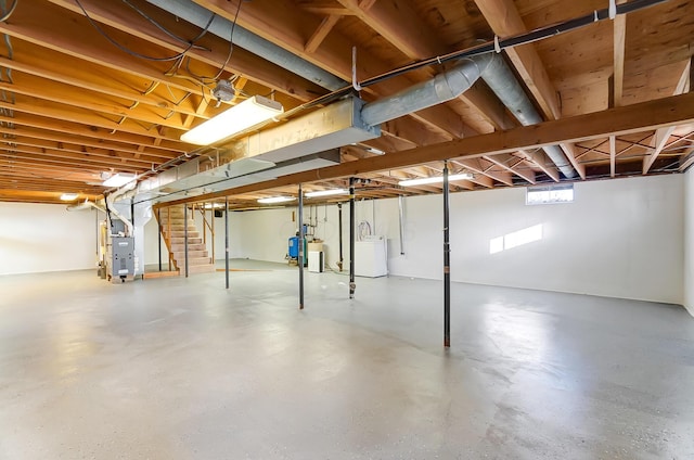 basement featuring washer and dryer and heating unit