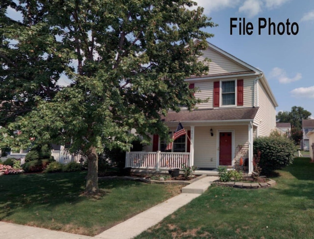 obstructed view of property with a porch and a front yard