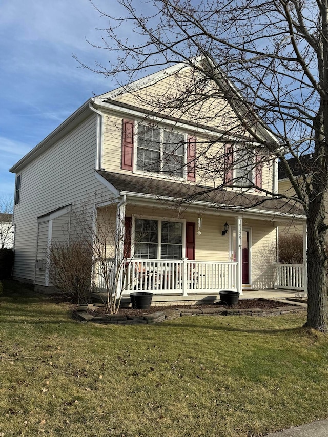 front facade with a front yard and covered porch