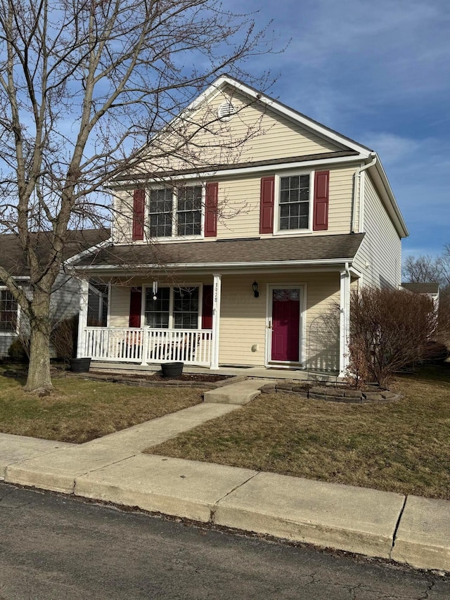 view of property featuring a front lawn and a porch