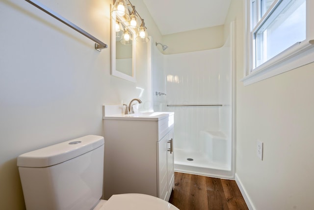 bathroom with vanity, a shower, and toilet