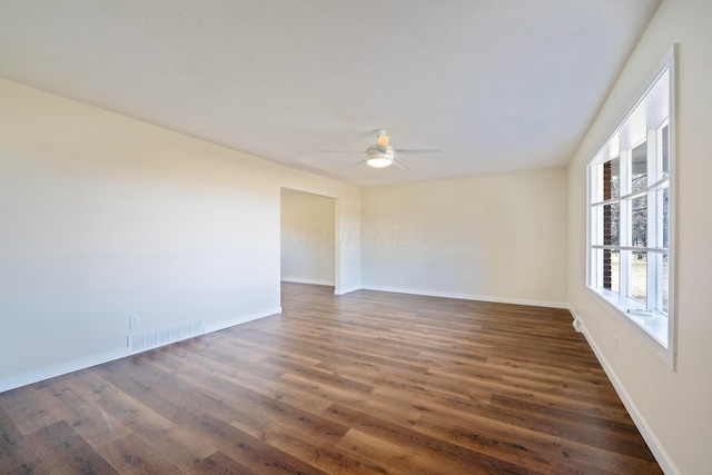 unfurnished room featuring ceiling fan and dark hardwood / wood-style flooring