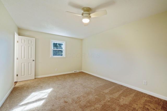 unfurnished room featuring light colored carpet and ceiling fan