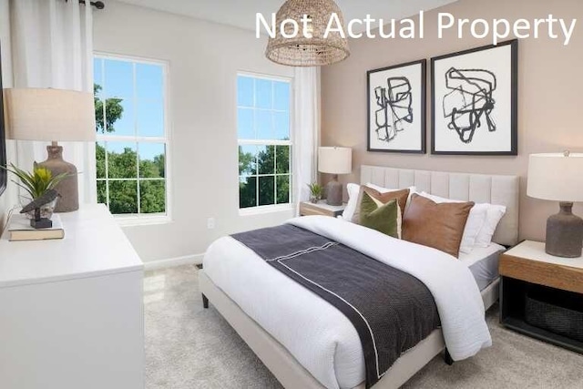 bedroom featuring light colored carpet