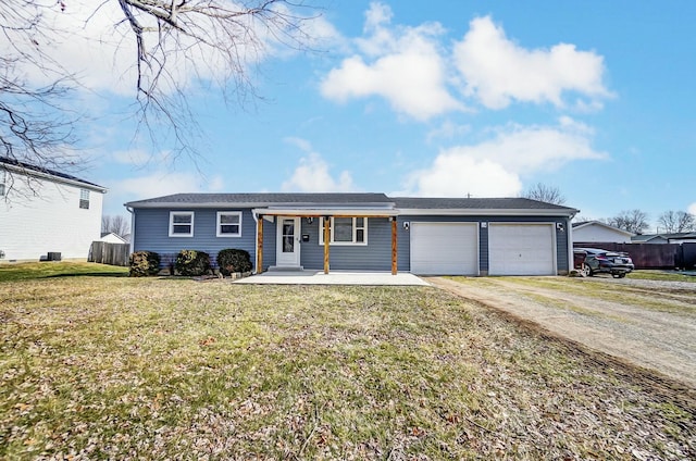 single story home featuring a porch, a garage, and a front lawn