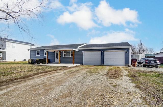 ranch-style home featuring a garage and covered porch