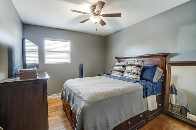 bedroom with ceiling fan and light hardwood / wood-style flooring