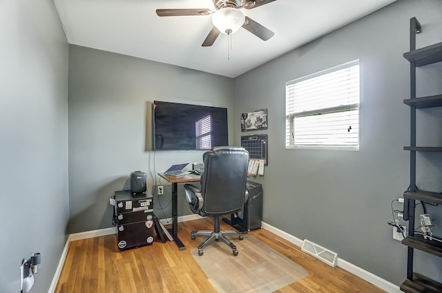 home office featuring hardwood / wood-style flooring and ceiling fan