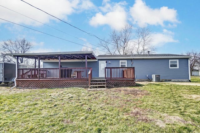 back of property with a wooden deck, a yard, and central AC unit