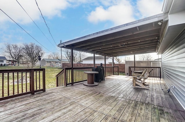 wooden terrace with a grill and a lawn