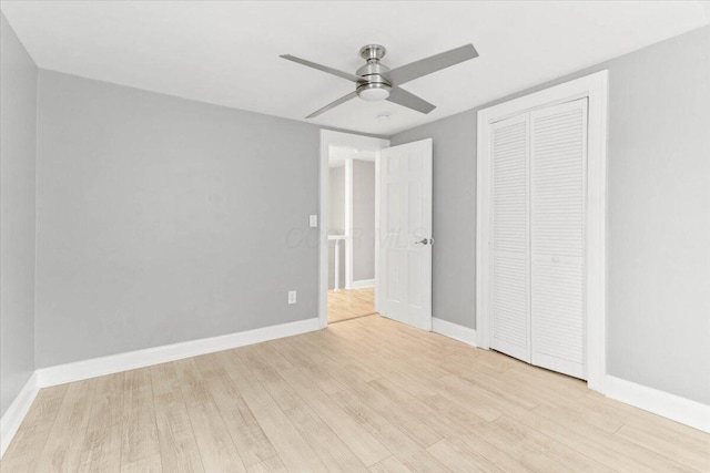 unfurnished bedroom with a ceiling fan, a closet, baseboards, and wood finished floors