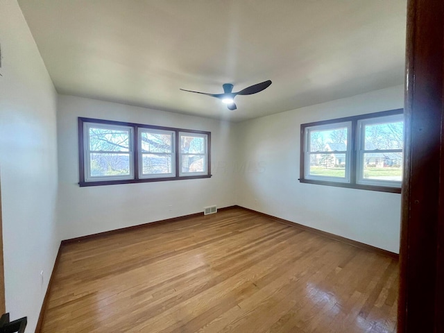 unfurnished room with ceiling fan and light wood-type flooring