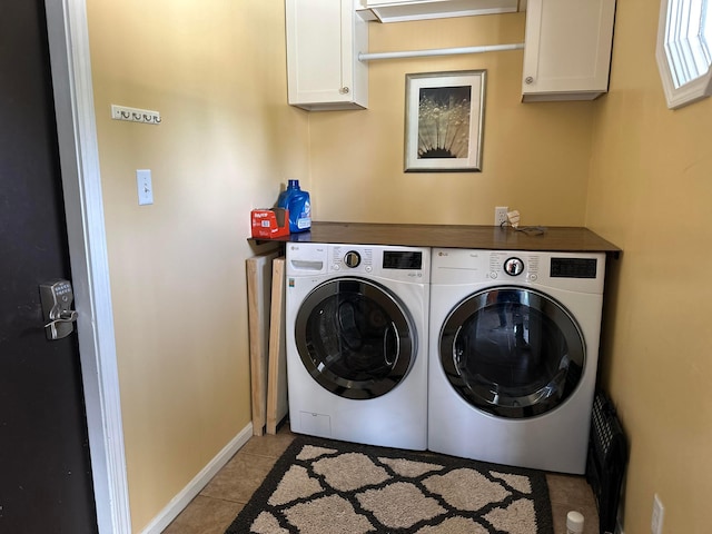 1048 Parkway Dr, Logan, OH 43138 - laundry room featuring cabinet space, washing machine and dryer, light tile patterned floors, and baseboards