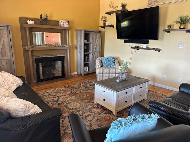 1048 Parkway Dr, Logan, OH 43138 - living area featuring a fireplace with flush hearth, baseboards, and wood finished floors