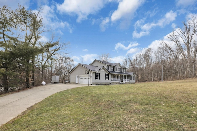 view of front of house with covered porch, concrete driveway, a front yard, and a garage