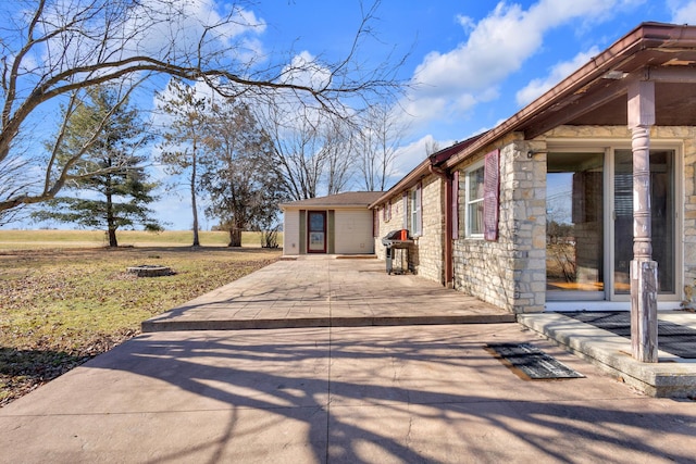 view of side of property featuring a patio area