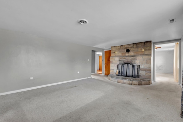 unfurnished living room with carpet floors and a fireplace