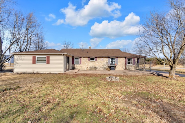 back of property with a patio and a lawn