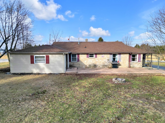 rear view of property featuring a yard and a patio area