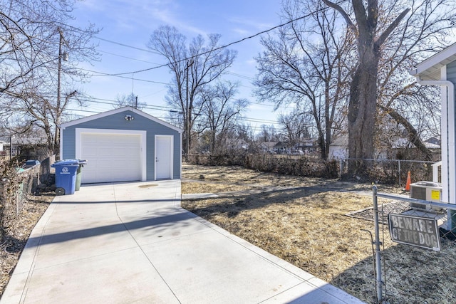 view of yard featuring a garage, an outdoor structure, and central AC unit