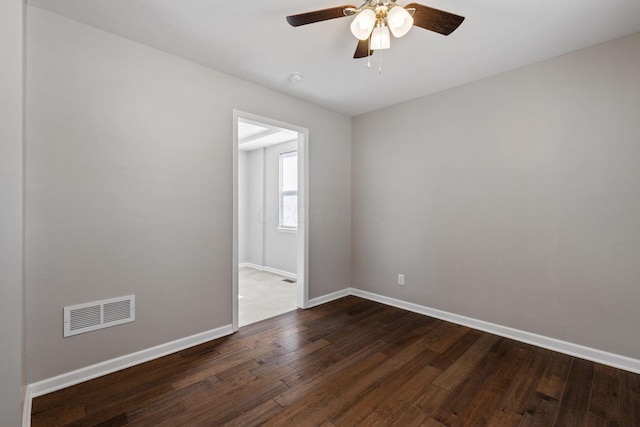 spare room with ceiling fan and dark hardwood / wood-style flooring