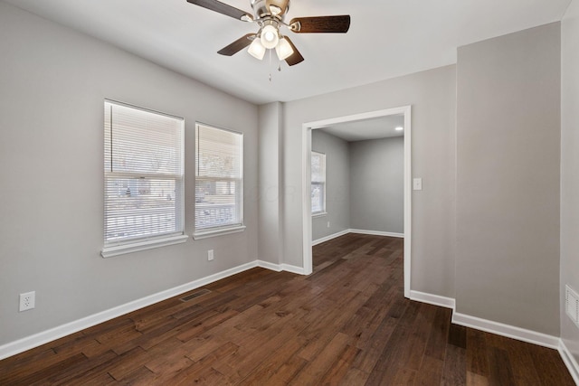 spare room with ceiling fan and dark hardwood / wood-style floors