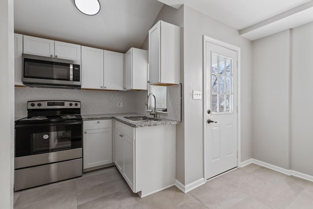 kitchen with white cabinetry, sink, backsplash, and stainless steel appliances