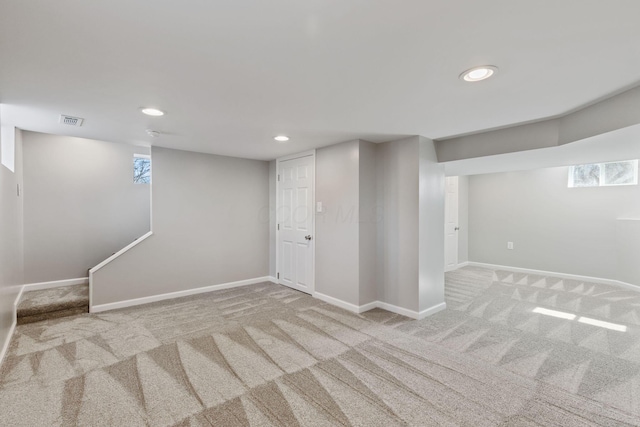 basement featuring light colored carpet and a wealth of natural light