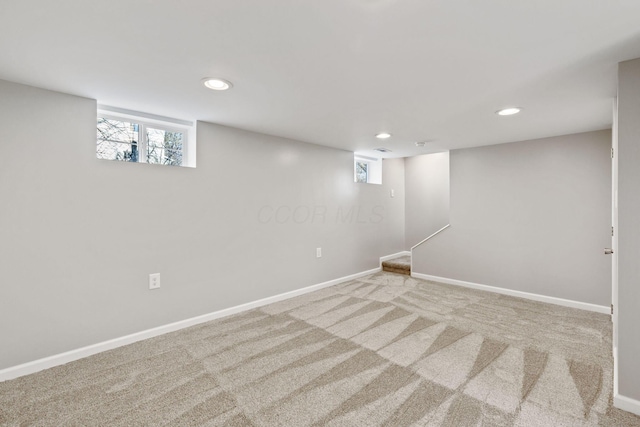 basement featuring light colored carpet