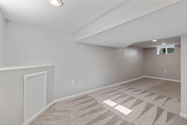 basement featuring light colored carpet