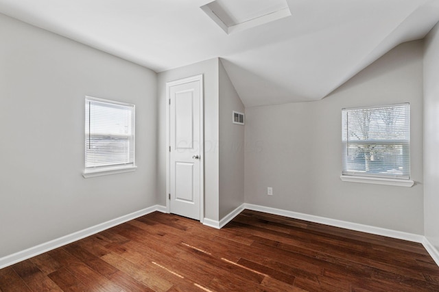 additional living space with lofted ceiling, dark hardwood / wood-style floors, and a healthy amount of sunlight