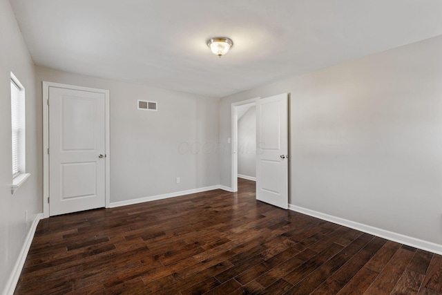 unfurnished room featuring dark hardwood / wood-style flooring