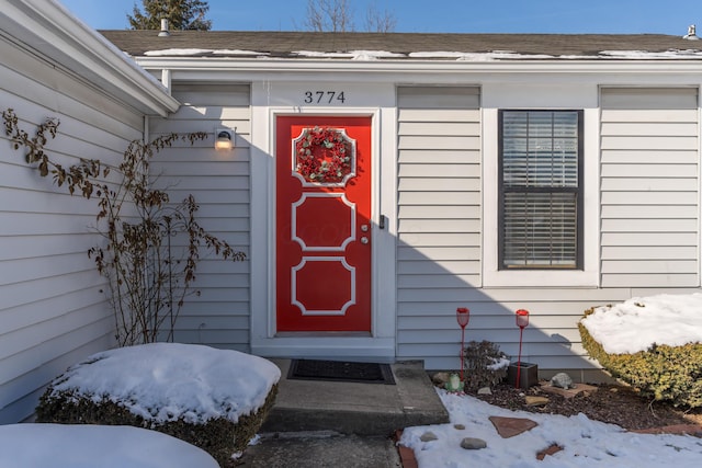 view of snow covered property entrance