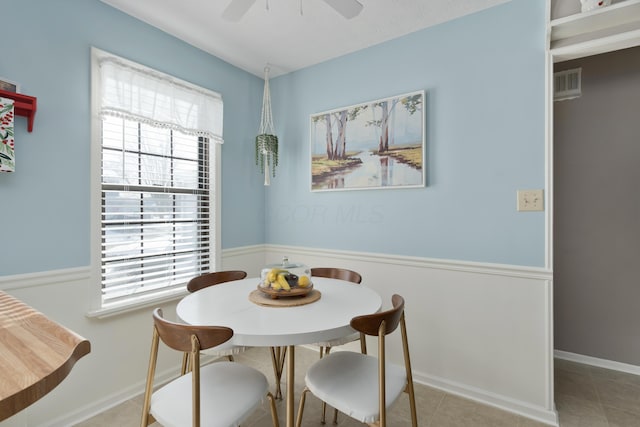 tiled dining room with ceiling fan