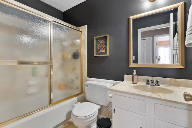 full bathroom featuring bath / shower combo with glass door, vanity, and toilet