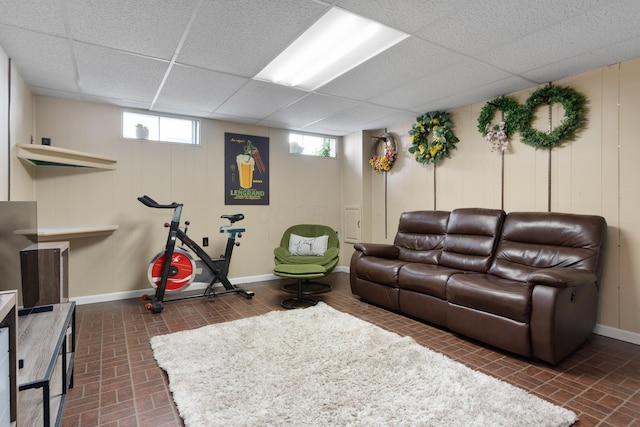 living room featuring a wealth of natural light and a paneled ceiling