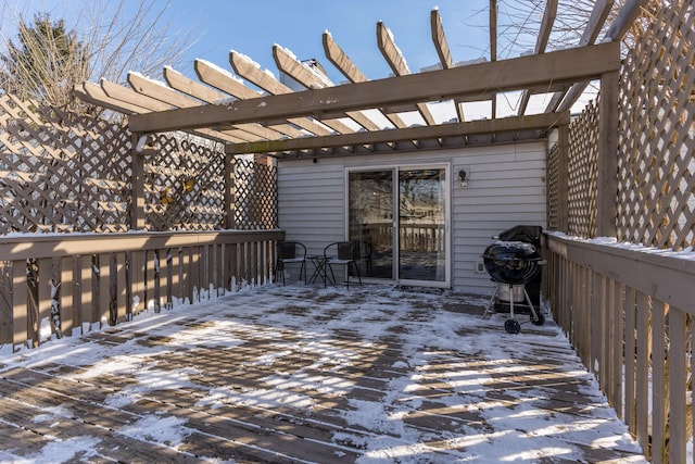 snow covered deck with a pergola