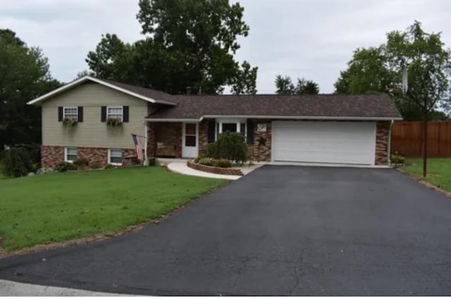 tri-level home featuring a garage and a front yard