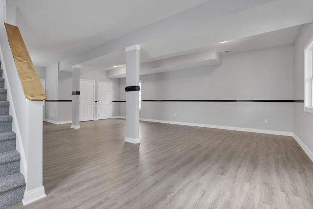 basement with light hardwood / wood-style flooring