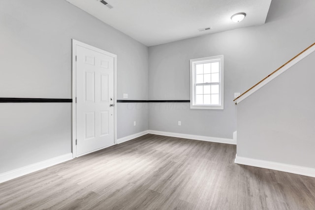 spare room featuring hardwood / wood-style flooring