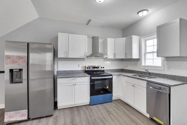 kitchen with sink, stainless steel appliances, white cabinets, and wall chimney exhaust hood