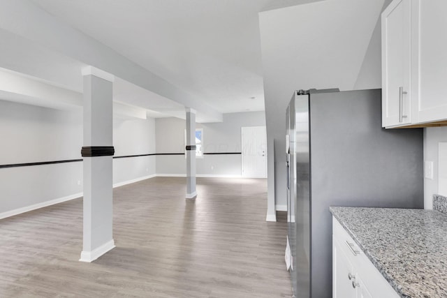 kitchen featuring white cabinetry, light stone counters, and light hardwood / wood-style floors